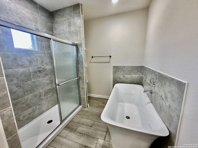 bathroom featuring plus walk in shower and sink