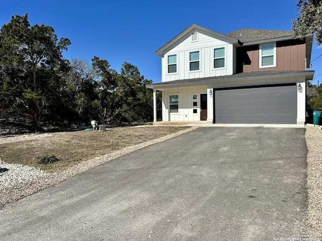 front facade with a porch and a garage