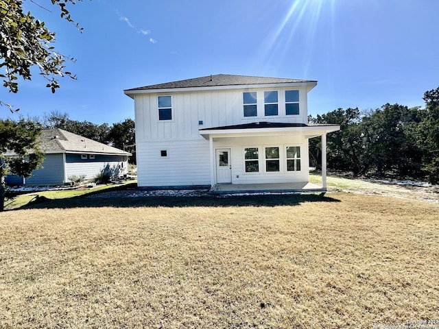 back of property with a lawn