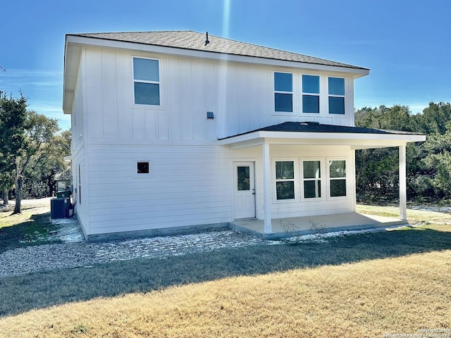 back of property featuring a patio, central AC, and a lawn