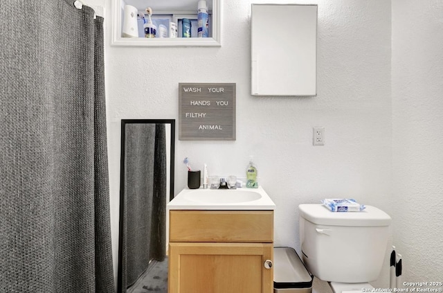 bathroom featuring vanity and toilet