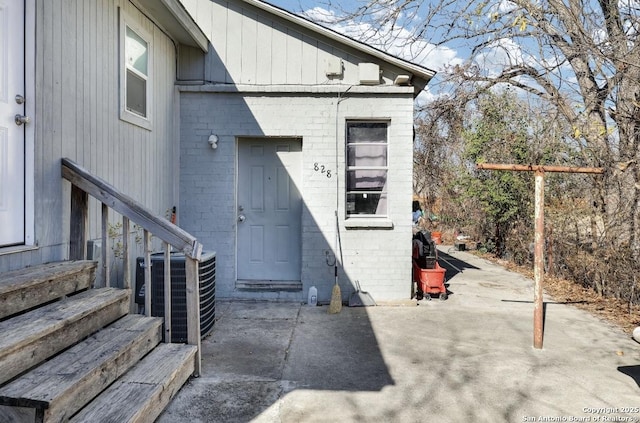 doorway to property with a patio and cooling unit