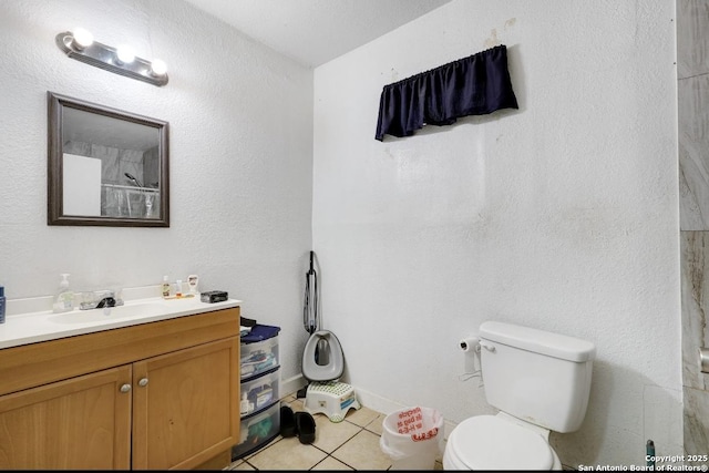 bathroom with vanity, tile patterned floors, and toilet