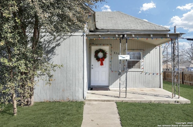 entrance to property with a lawn