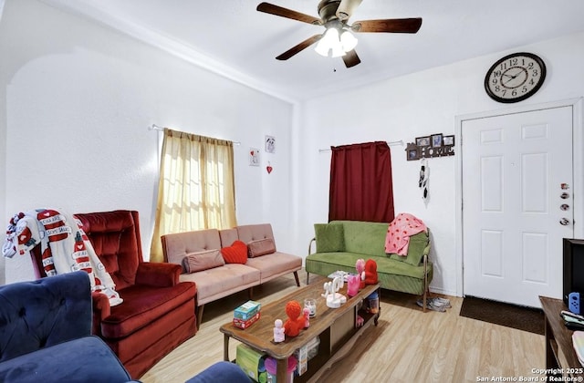 living room featuring ceiling fan and light hardwood / wood-style floors