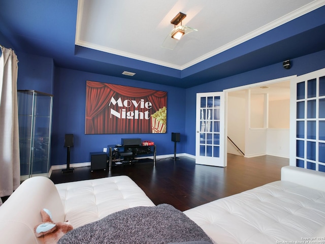 bedroom with french doors, ornamental molding, a raised ceiling, and hardwood / wood-style floors