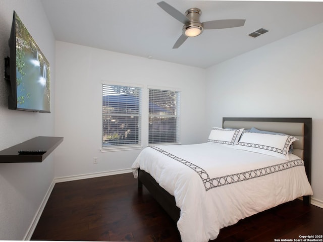 bedroom with ceiling fan and dark hardwood / wood-style flooring