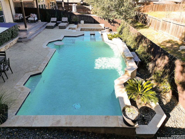 view of swimming pool featuring a patio area