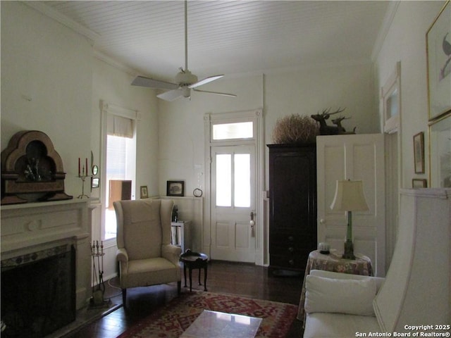 living room featuring crown molding, dark hardwood / wood-style floors, and ceiling fan