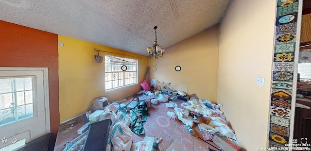 misc room with a chandelier and a textured ceiling