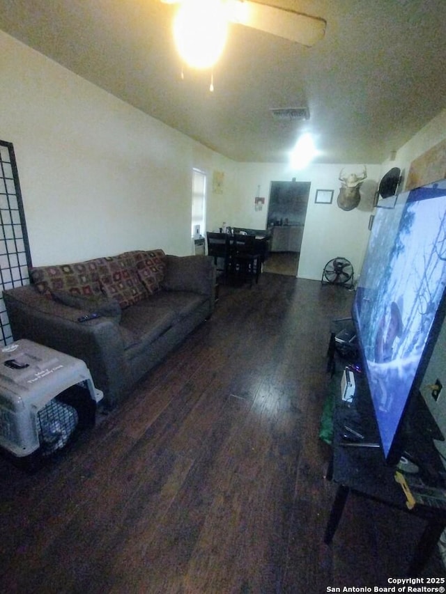 living room featuring hardwood / wood-style flooring and ceiling fan