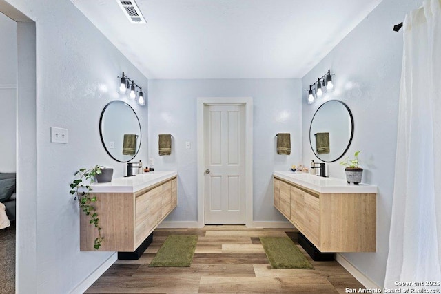 bathroom with vanity and hardwood / wood-style floors