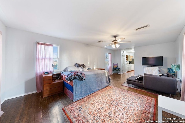 bedroom with dark hardwood / wood-style floors and ceiling fan