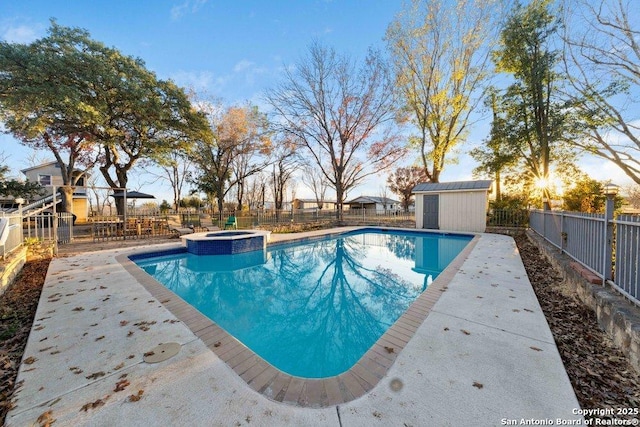 view of pool featuring an in ground hot tub, central AC, and a storage shed