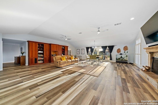 unfurnished living room with ceiling fan, lofted ceiling, and hardwood / wood-style floors