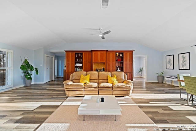 living room featuring lofted ceiling, hardwood / wood-style floors, and ceiling fan