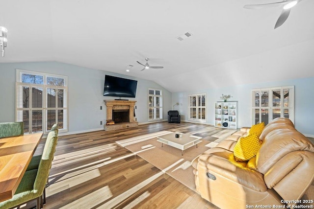 living room featuring lofted ceiling, hardwood / wood-style floors, and ceiling fan