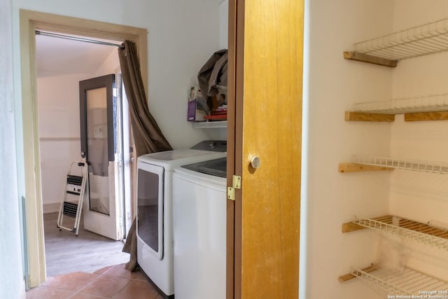 laundry area with tile patterned flooring and independent washer and dryer