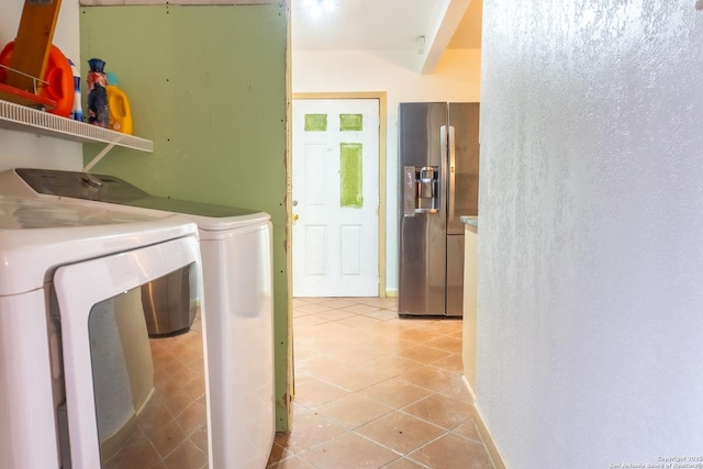 laundry area with light tile patterned flooring and washer and clothes dryer