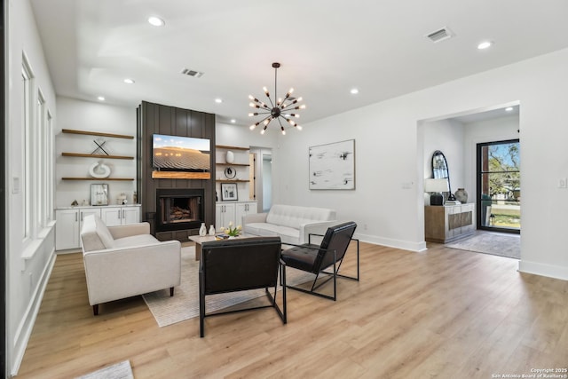 living area with light wood-type flooring, a fireplace, and visible vents