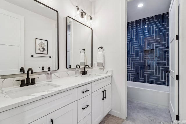 bathroom with double vanity, a sink, and shower / bathtub combination