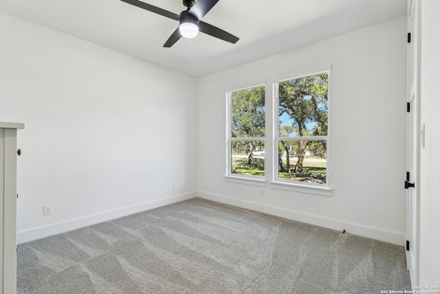 empty room featuring ceiling fan, carpet, and baseboards