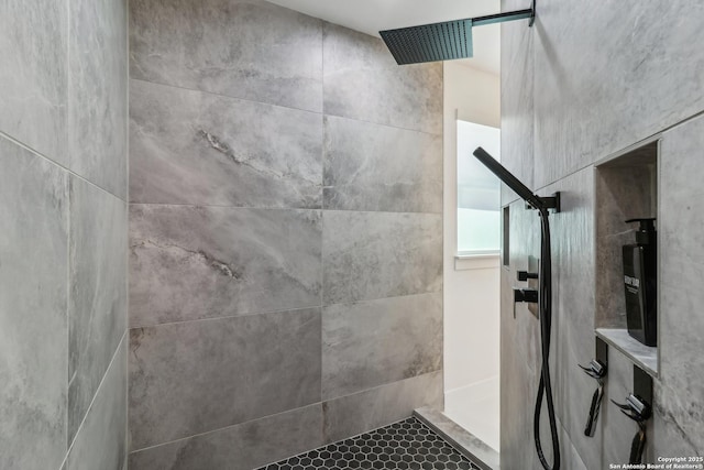 full bath with a tile shower