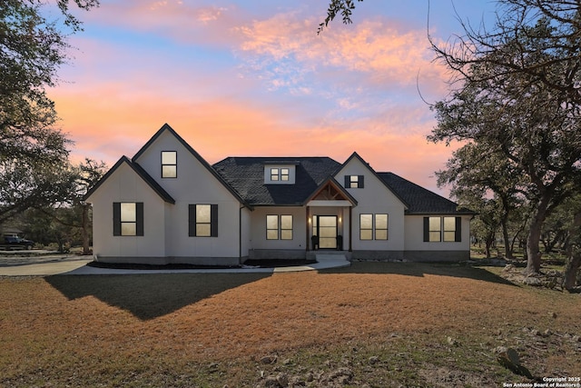 modern inspired farmhouse featuring a front lawn