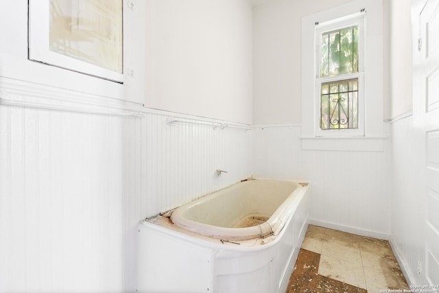 bathroom with a tub to relax in