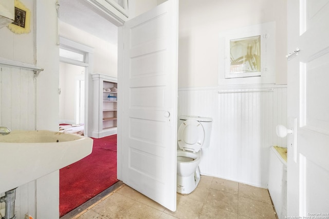 bathroom with tile patterned flooring, sink, and toilet