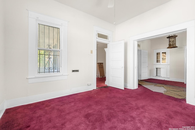 unfurnished bedroom featuring lofted ceiling, ceiling fan, and carpet