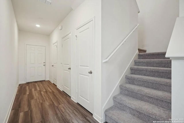 stairway with hardwood / wood-style floors