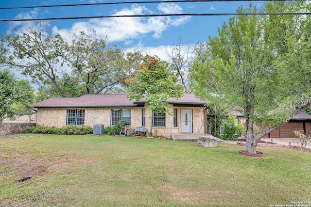 ranch-style home featuring central AC and a front yard