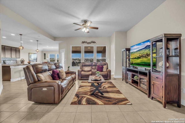 tiled living room featuring ceiling fan and a textured ceiling