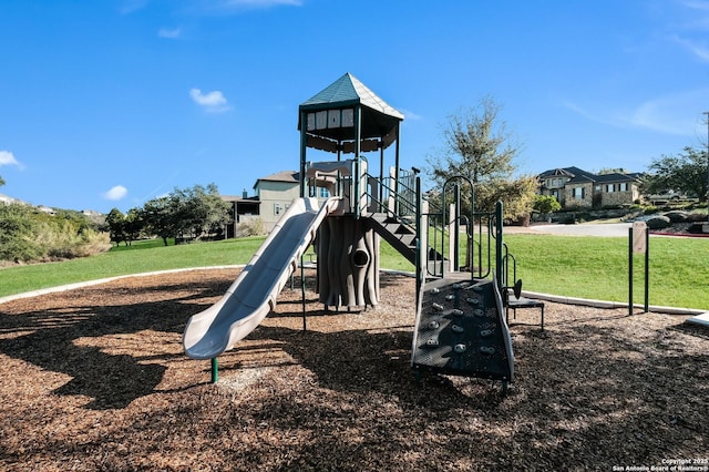 view of playground with a lawn