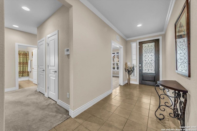 tiled foyer entrance featuring ornamental molding