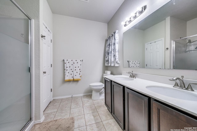 bathroom featuring vanity, tile patterned flooring, a shower with shower door, and toilet