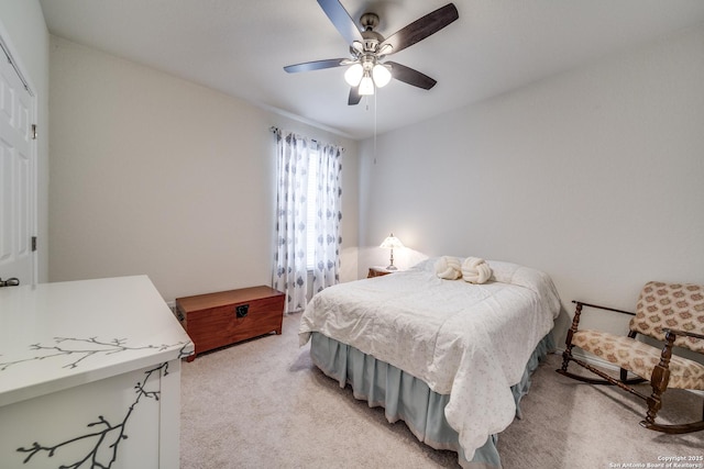 bedroom featuring light colored carpet and ceiling fan