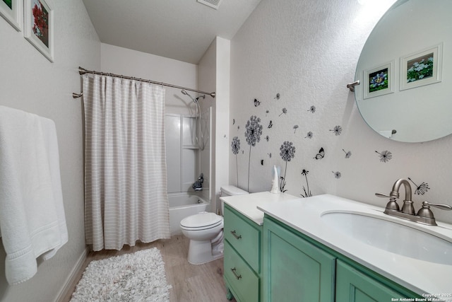 full bathroom with hardwood / wood-style flooring, vanity, toilet, and shower / tub combo