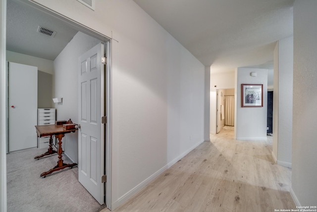 hall with light hardwood / wood-style flooring