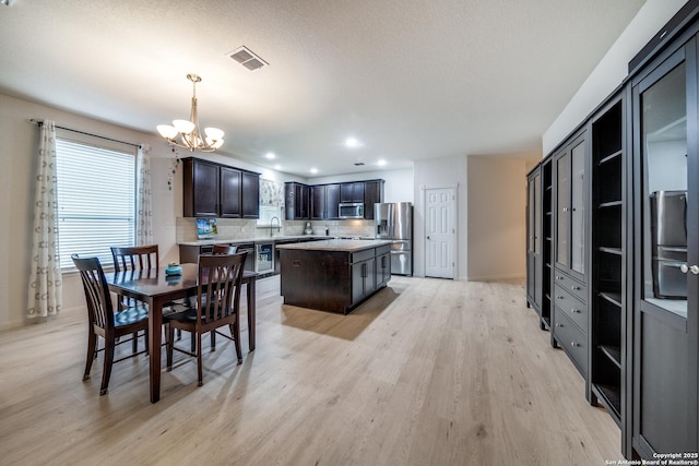 dining space with a chandelier and light wood-type flooring