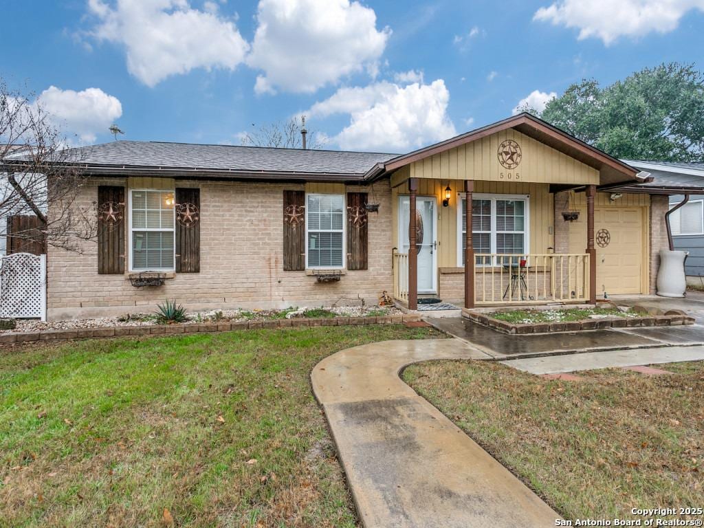 ranch-style house with a garage, covered porch, and a front lawn