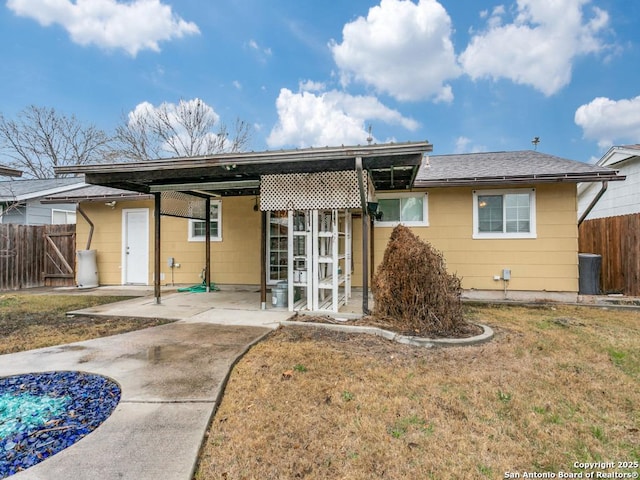 back of property featuring a yard and a patio area