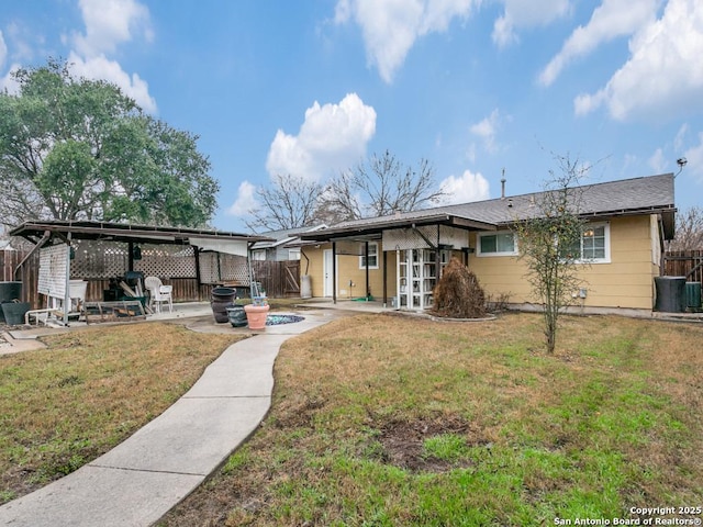 rear view of house featuring a yard, a patio area, and french doors