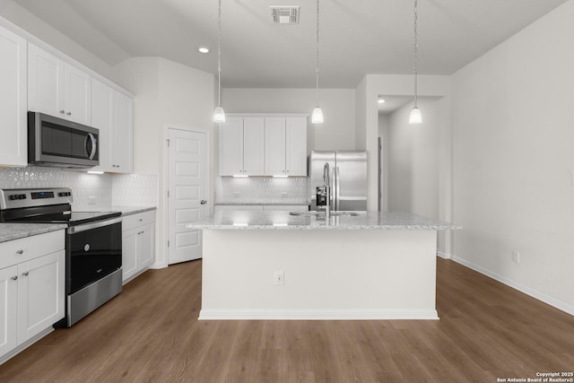 kitchen featuring stainless steel appliances, an island with sink, and white cabinetry