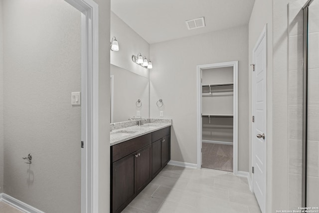 bathroom with vanity and tile patterned flooring