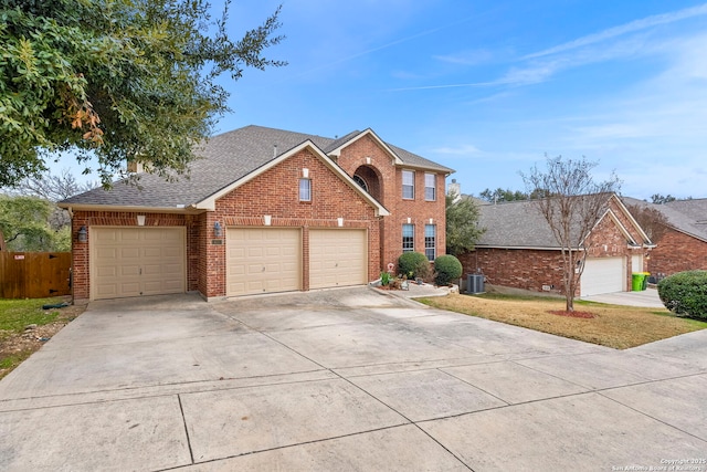 view of front property with a garage and central air condition unit