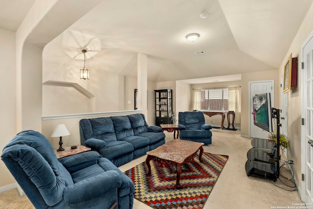 living room with light carpet and vaulted ceiling