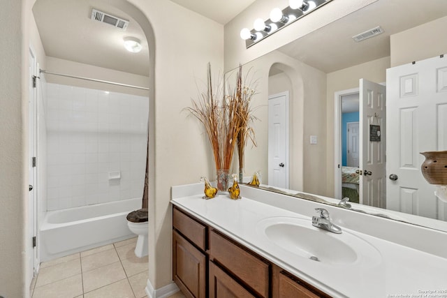 full bathroom featuring tile patterned flooring, vanity, tiled shower / bath combo, and toilet