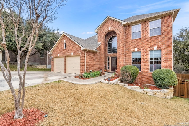 view of front of property with a garage and a front lawn